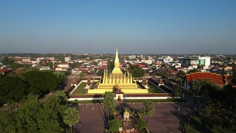 Aerial-drone-shot-of-Pha-That-Luang-Golden-Stupa-in-Vientiane,-Laos