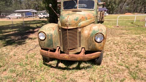 old rusty truck stationary in a grassy area