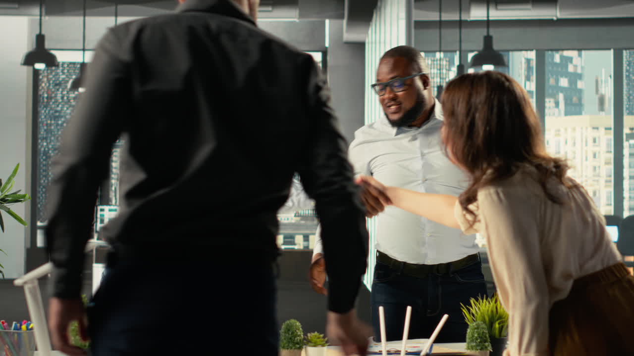 Business people greeting each other in office before a briefing meeting