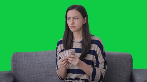 Sad-Indian-girl-losses-money-while-counting-Green-screen