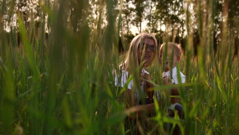 Loving-mother-and-son-in-the-field-to-communicate-and-hug,-the-sun's-rays-illuminate-the-hair.-Happy-family