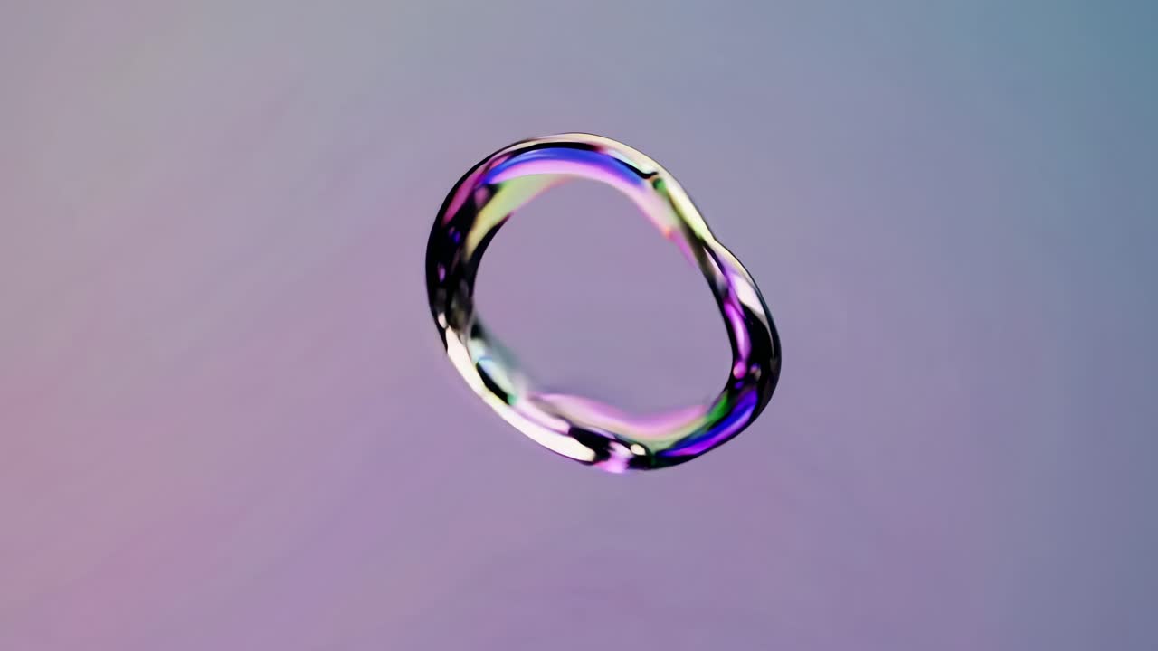 Abstract video concept with a floating, iridescent ring. Captured from a side angle, it showcases