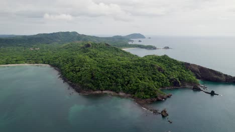 a 4k drone shot of punta sabana point and the mirador conchal peninsula next to puerto viejo and playa conchal, or “shell beach”, along the north-western coast of costa rica