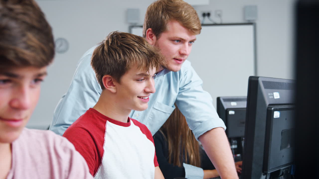 Teenage Students Studying In IT Class With Teacher
