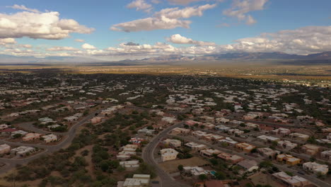 town of green valley arizona, clouds with blue sky, drone forward