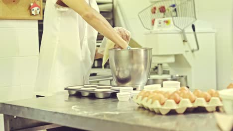 Confectioner-filling-pastry-bag-with-dough