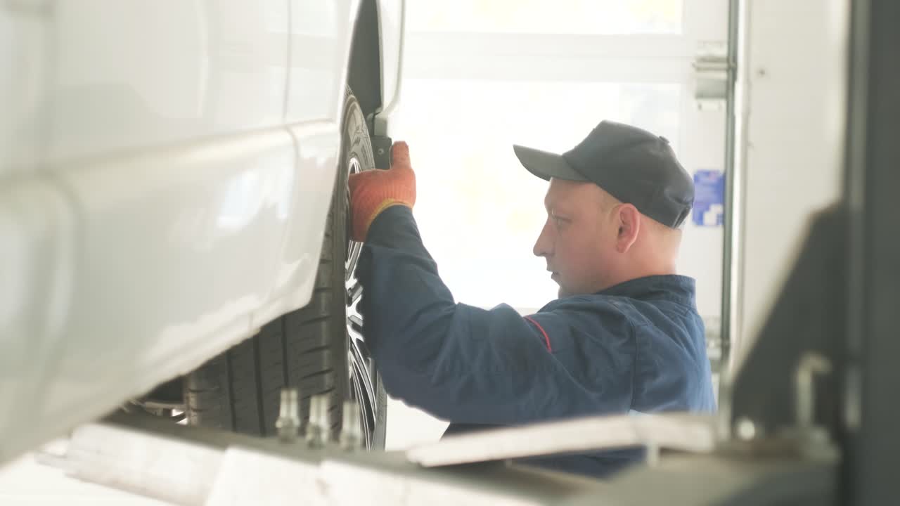 Mechanic inspecting a car's wheel
