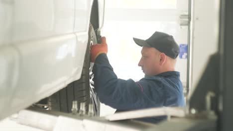 mechanic inspecting a car's wheel