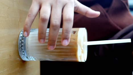 close-up of an iced coffee being enjoyed in a cafe