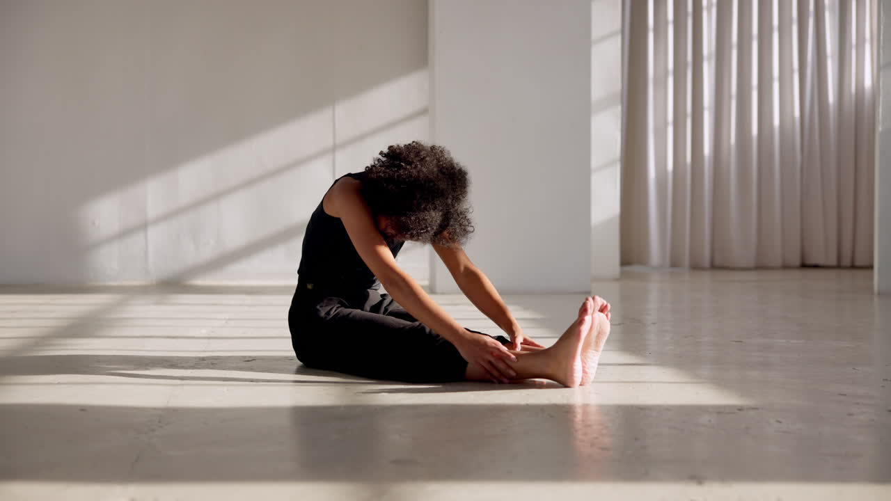 Dancer, stretching back and training legs
