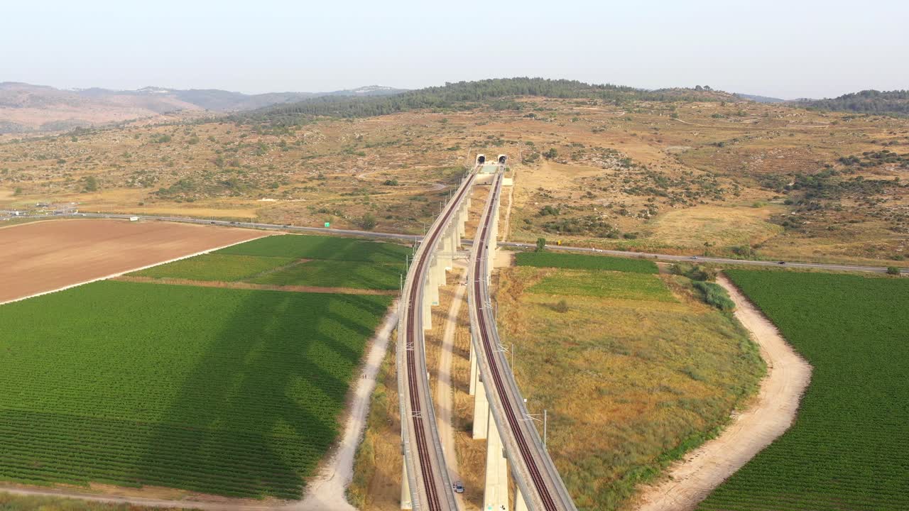 Aerial View of a Modern Train Bridge and Tunnel in a Rural Landscape