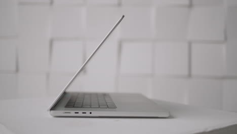 silver laptop on white table