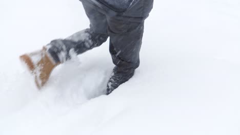 person walking through deep snow