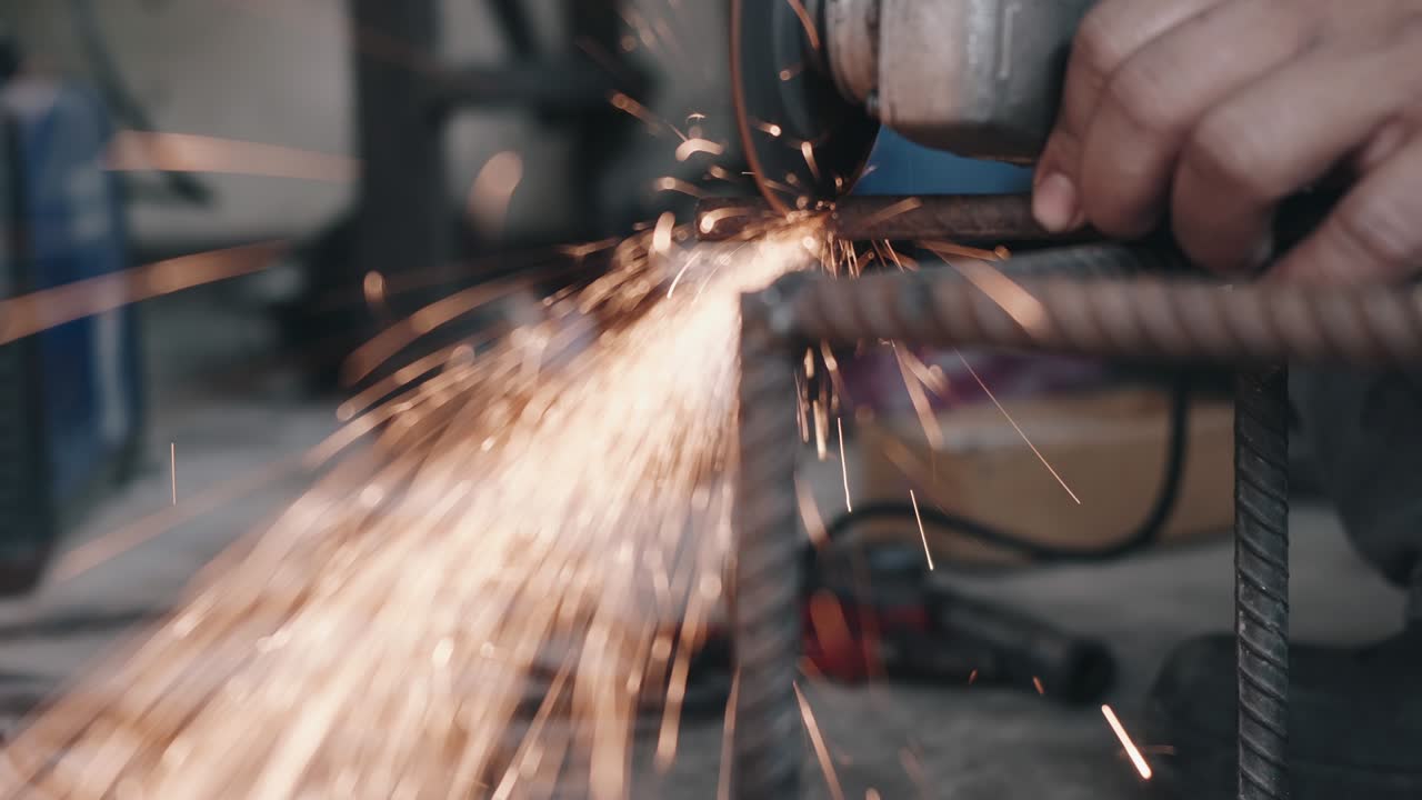 trabajador que utiliza una rueda eléctrica para moler y cortar la estructura de acero