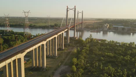 Aerial-establishing-shot-of-Zarate-Brazo-Largo-bridge-crossing-the-Parana-river-at-sunset