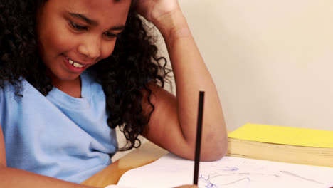 Young-little-girl-drawing-with-pencil