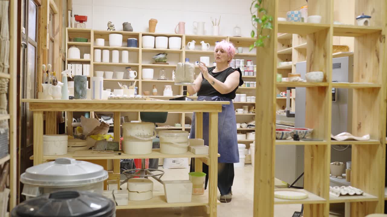 Artist creating pottery in a ceramics studio