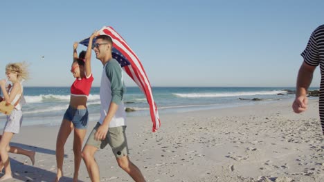 young adult friends having fun walking on a beach 4k