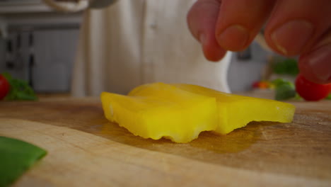 cutting a yellow bell pepper