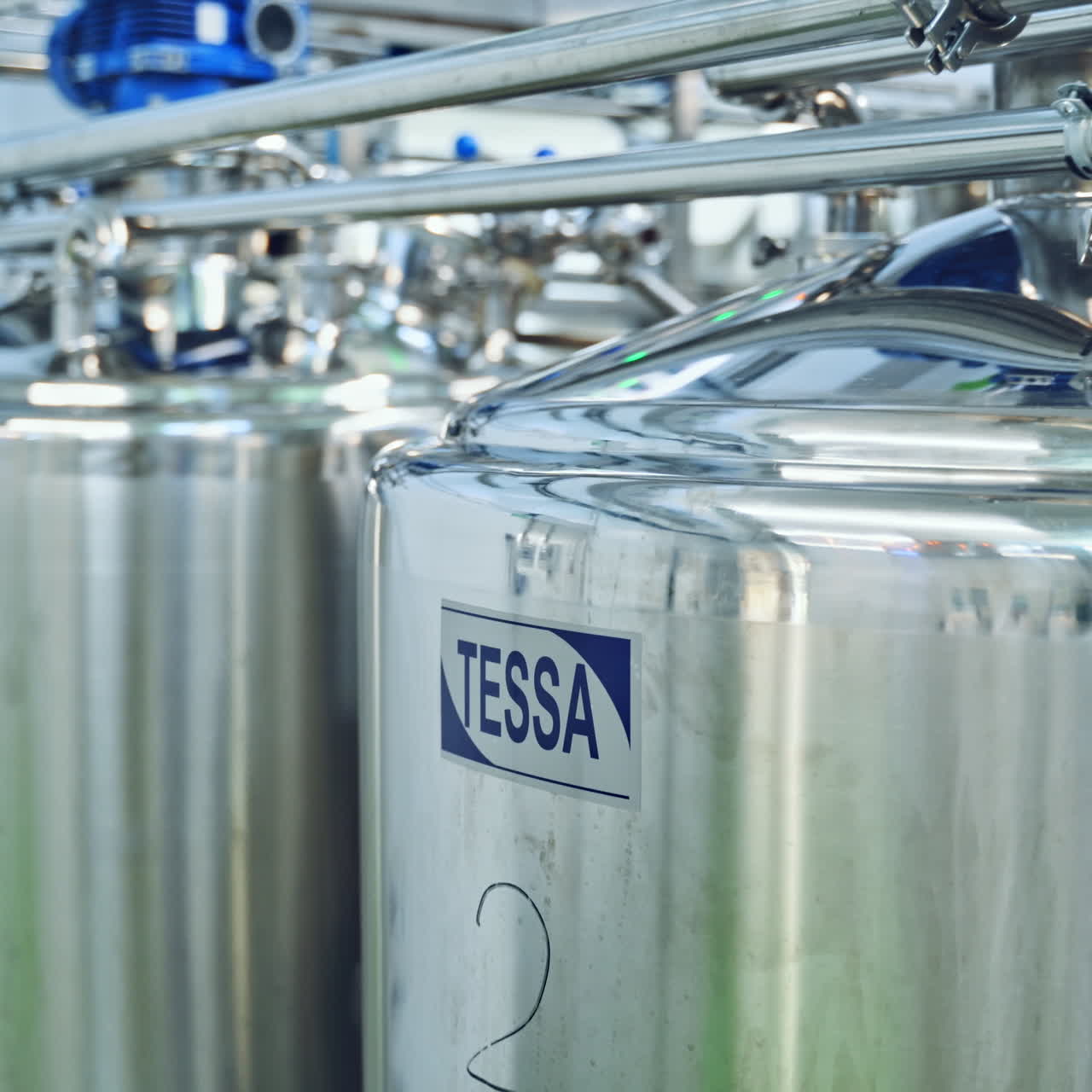 Manufacturing plant inside. Production of dairy cheese in a modern factory. Manufacturing of dairy products. Milk products inside big bowls.