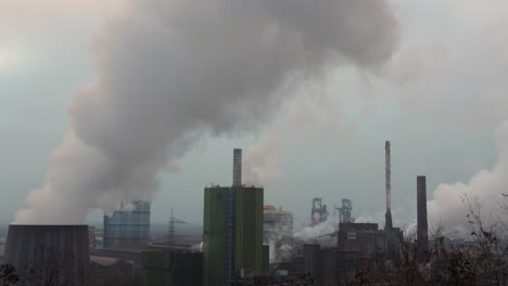 Cooling towers of a factory releasing white smoke to atmosphere