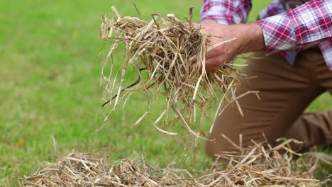 close up on a man touching straw