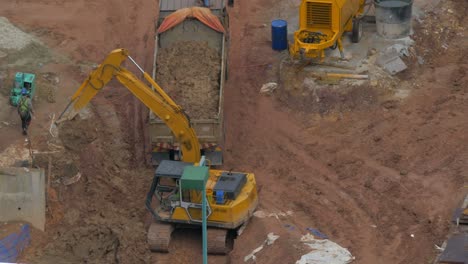 excavator loading truck on construction site