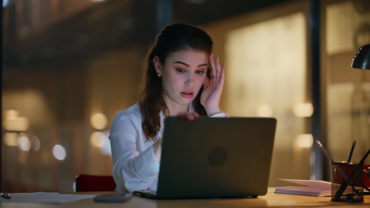 Overworked employee frustrated overtime work in night office closeup. Tired lady