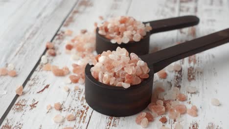 pink salt in wooden spoons