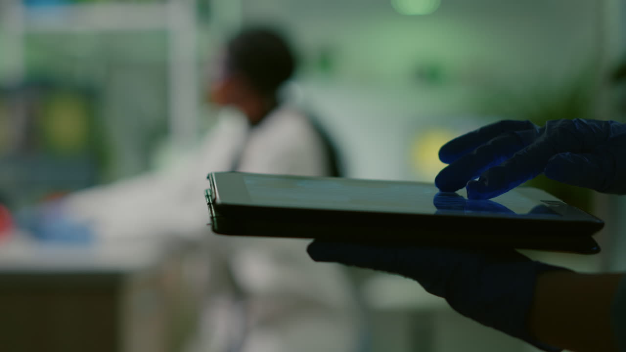 Scientist researcher doctor analyzing genetic mutation test using tablet