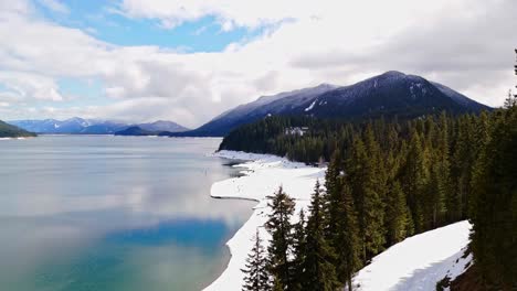 scenic view on lake kachess over evergreen trees and snow in washington state