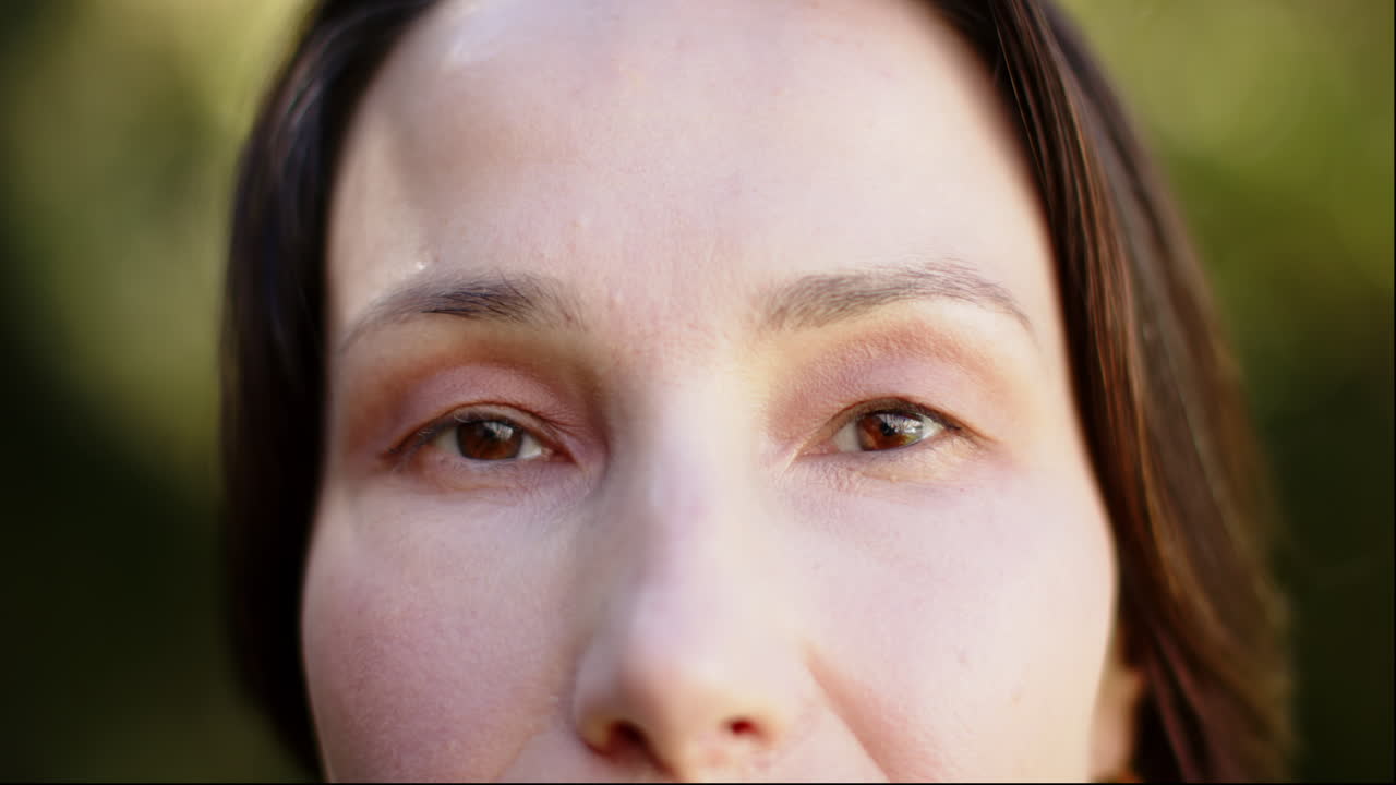 Close-up of woman's face with natural makeup, focusing on eyes and skin