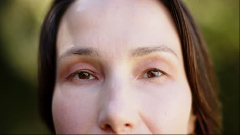close-up of woman's face with natural makeup, focusing on eyes and skin