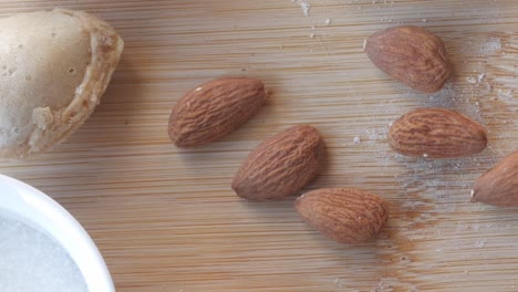 panning view of sugar biscuits, almond and cake in a wooden table. close-up