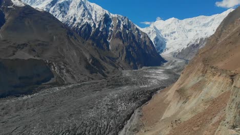 aerial over hopar glacier in nagar valley with snow capped mountains