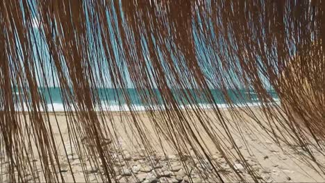 Beach-umbrella-moved-by-wind-on-a-beautiful-sunny-day-in-benalmadena,-Spain