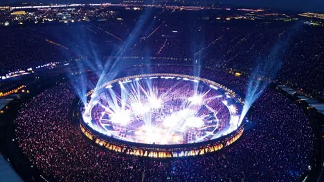 aerial view of a large concert with a huge crowd and bright lights