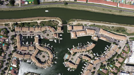 Aerial-top-view-over-Aigues-Mortes-marina-with-boats-passing-sunny-summer-day