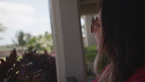 close-up shot of a woman wearing a sunglasses relaxing at her porch