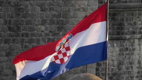 4k. flag of croatia waving in the wind on the walls of dubrovnik