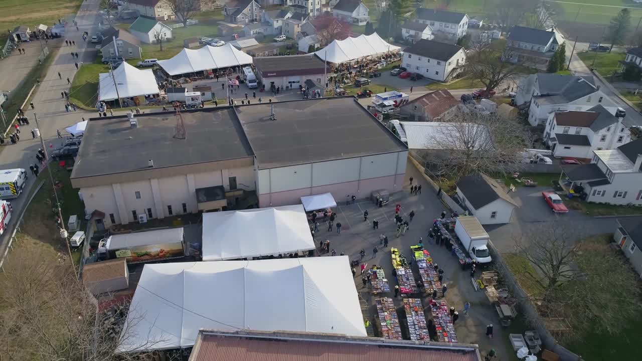 Aerial of an Early Morning View of Opening Day at an Amish Mud Sale Selling Farm Equipment to Quilts