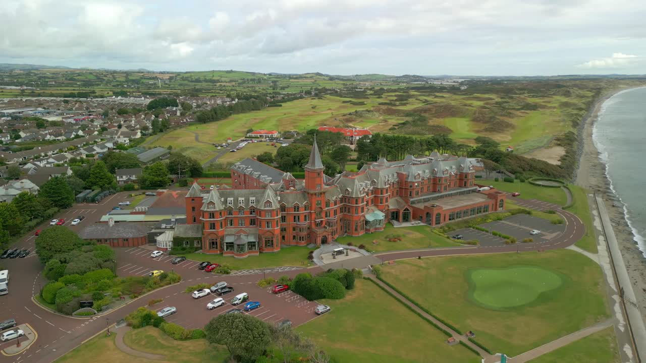 4K, 60FPS aerial video of the Slieve Donard Hotel in Newcastle, County Down in Northern Ireland. The camera moves away, rising as it ascends
