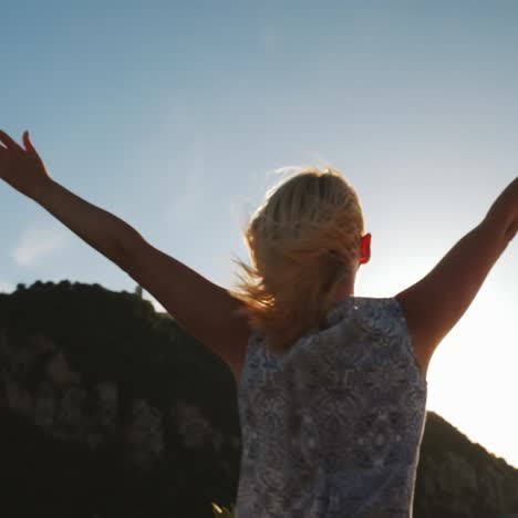 A-Woman-Dances-On-A-Yacht-Against-The-Backdrop-Of-The-Setting-Sun