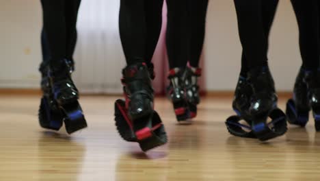sports girls perform synchronous jumps in the gym