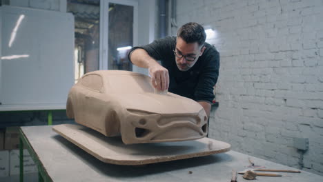 sculpting a clay car model