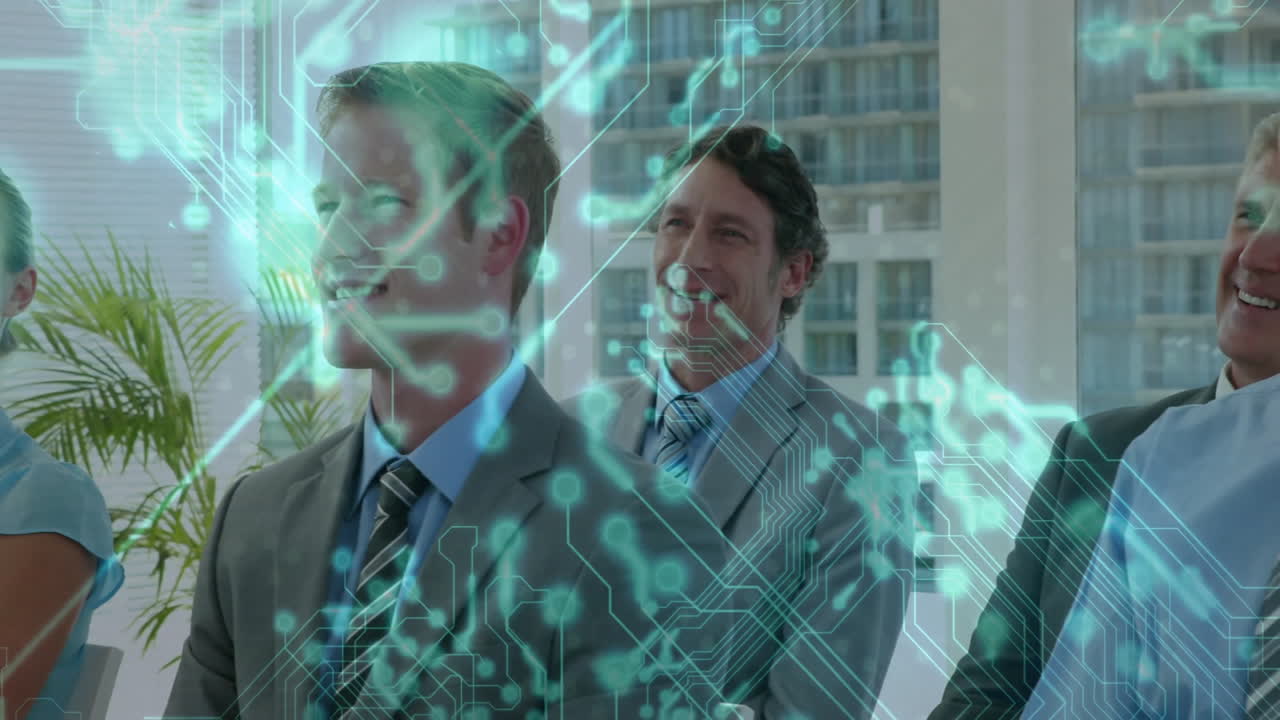 Colleagues watching business presentation in conference room, displaying green circuit overlay