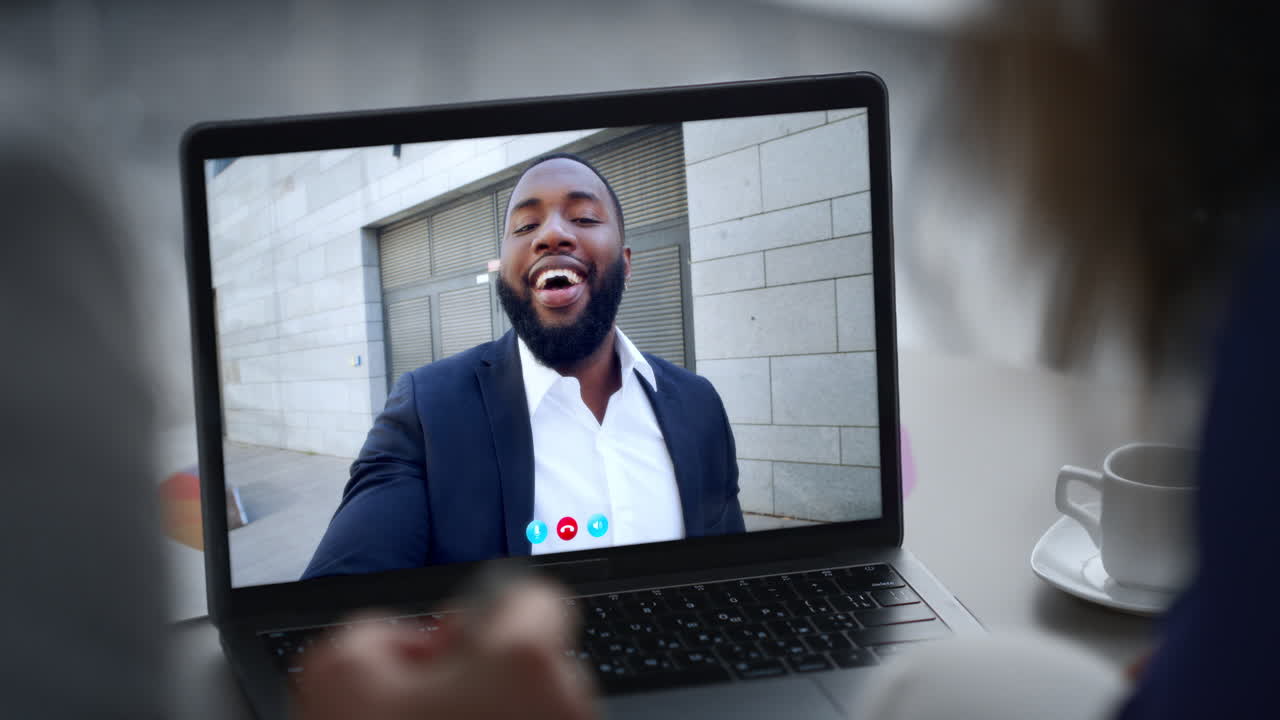 Coworkers communicating video chat at laptop close up. Unknown couple greeting