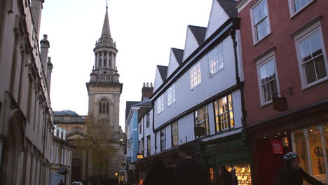 exterior of shops and church in oxford city centre at dusk