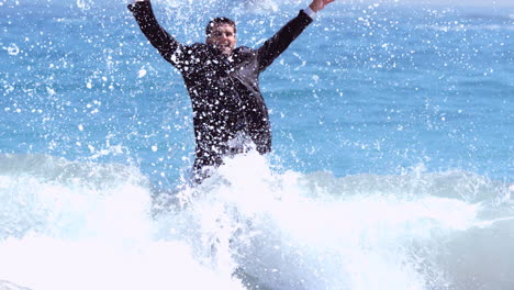 businessman jumping in the waves