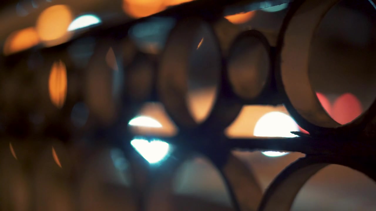 Nighttime Traffic Scene With Colorful Car Lights Creating A Soft Blurred Bokeh Effect Behind Bridge Railings, Capturing Atmospheric Urban Movement, Road Traffic And Vibrant City Lights